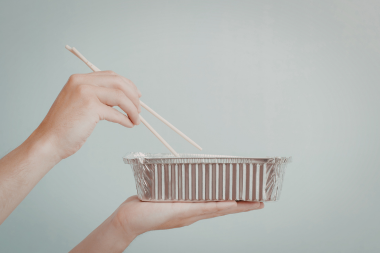 what living without a kitchen is really like during a remodeling project homeowner holding takeout container and chopsticks custom built michigan