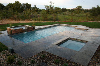 concrete pool decks an honest review large swimming area with hot tub and waterfall custom built michigan