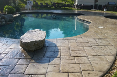 concrete pool decks an honest review stamped design with unique shaped swimming area custom built michigan