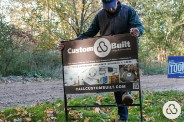 Greater Lansing home remodeling contractor placing yard sign