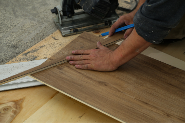 Greater Lansing home remodeling contractor measuring luxury vinyl tile