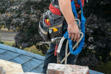 Greater Lansing roofing contractor inspecting shingles