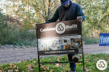 Greater Lansing home remodeling contractor installing yard sign