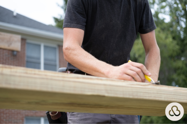 Greater Lansing home improvement company remodeler measuring wood board