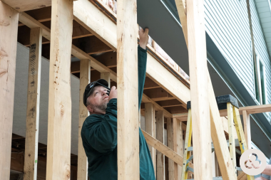 Greater Lansing home remodeling contractor installing wood beams