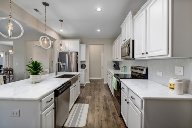 Greater Lansing kitchen remodeling project with large island and white cabinets