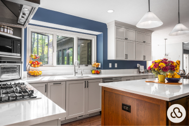 luxury kitchen remodeling project in Greater Lansing built by Custom Built Design and Remodeling with blue walls and updated appliances
