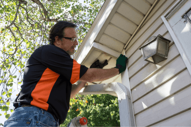 Greater Lansing home remodeler inspecting house siding panels