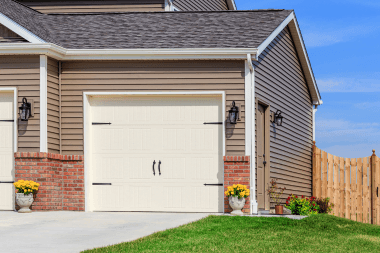 Greater Lansing home with vinyl siding and garage door