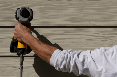 Greater Lansing siding replacement contractor installing panels