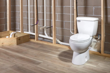 Greater Lansing basement bathroom with new toilet and plumbing pipes