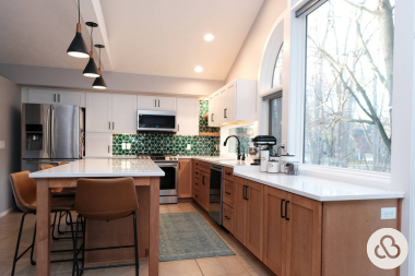 Greater Lansing luxury kitchen remodeling project built by Custom Built Design and Remodeling with large sink window and green tile backsplash