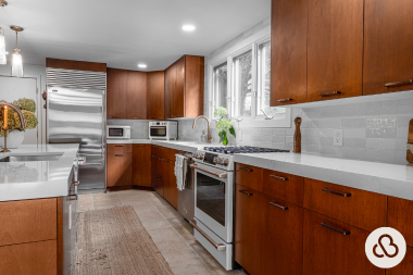 Greater Lansing area kitchen remodeling project built by Custom Built Design and Remodeling with refaced wood cabinets and tile backsplash