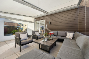 sunroom addition cost vs roi is it a smart investment three season space with modern wicker furniture and siding custom built michigan