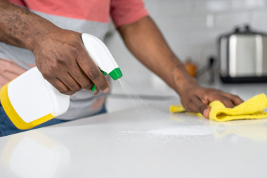 home remodeling problems families face during planning homeowner spraying and cleaning kitchen countertop custom built michigan