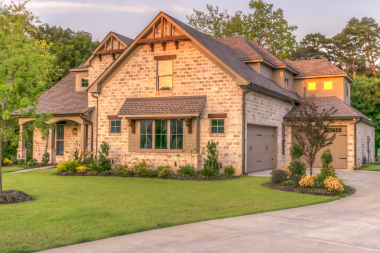 seasonal landscaping tips for year round beauty brick home with large front lawn and trimmed foliage custom built michigan