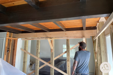 how we resolved an unforeseen change order during a deck project contractor installing new wood structural beams custom built michigan