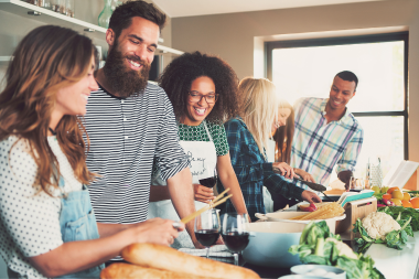 what are the benefits of kitchen remodeling homeowners and friends cooking dinner together at island custom built michigan