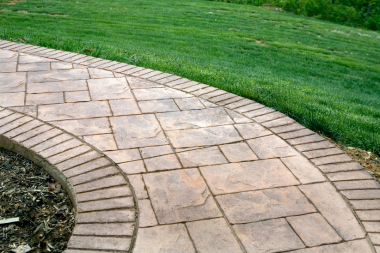 top pathway and walkway ideas for your michigan outdoor living space stamped concrete path with brick borders custom built okemos