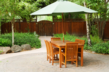 mistakes to avoid while choosing your outdoor furniture large backyard patio space with wood dining table and umbrella custom built michigan