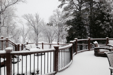 deck replacement in northern michigan what vacation homeowners should know snow covered outdoor living space with composite decking custom built boyne city
