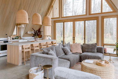 home lighting design tips to brighten shorter fall days open concept living room with large windows for natural light custom built michigan
