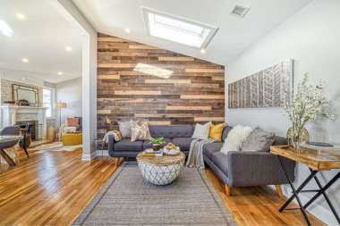 home lighting design tips to brighten shorter fall days accent shiplap wall with large skylight custom built michigan
