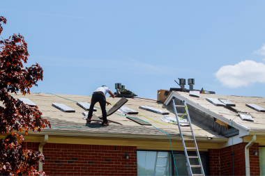 misconceptions about roof replacement projects in michigan contractors removing old roofing shingles custom built okemos
