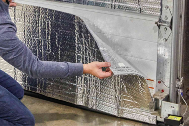 ways to improve home insulation homeowner installing reflective material in basement custom built michigan