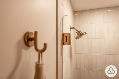bathroom remodel cost myths every homeowner should know bronze finished robe hook and showerhead custom built michigan