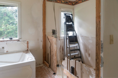 bathroom remodel cost myths every homeowner should know ladder leaning against window during remodeling project custom built michigan