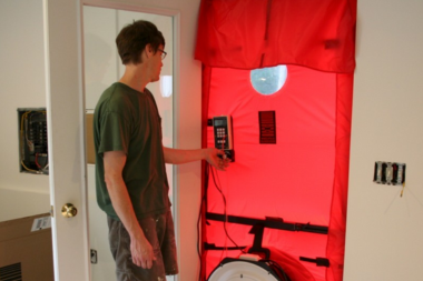 how to prioritize home remodeling projects when you cant do them all remodeler performing blower door test custom built michigan