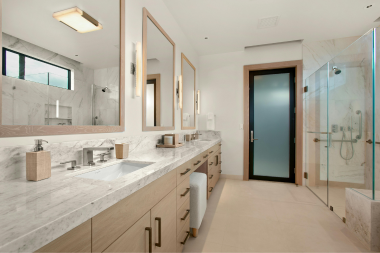 how to prioritize home remodeling projects when you cant do them all primary bathroom remodel with large sink vanity and luxury shower custom built michigan