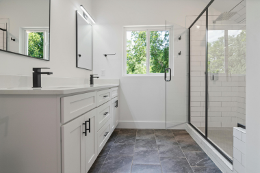 tips for designing a functional guest bathroom double sink vanity next to large shower space custom built michigan