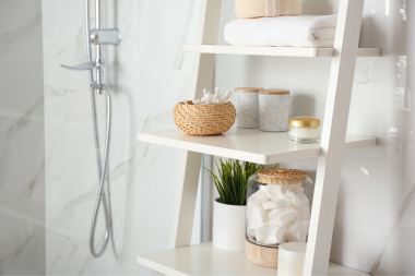 tips for designing a functional guest bathroom wood shelving with amenities next to shower custom built michigan