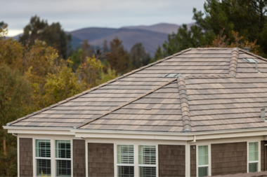 comparing michigan roof design types for your home large house with hip roof and windows custom built okemos