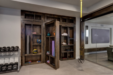 home gym ideas for your remodel basement workout space with hidden door and shelf storage custom built michigan