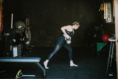 home gym ideas for your remodel homeowner exercising in finished garage with kettlebell custom built michigan