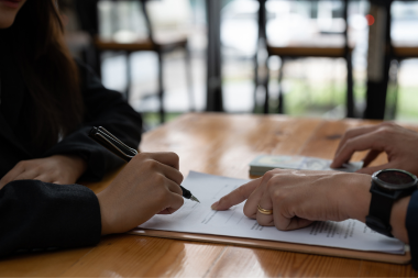 mistakes to avoid while financing your home remodel homeowner signing loan document custom built michigan