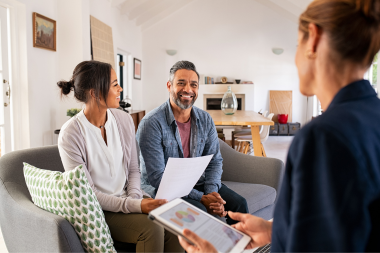 mistakes to avoid while financing your home remodel homeowners discussing remodeling loan options with lender in living room custom built michigan