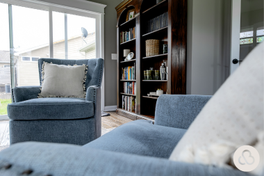 mistakes to avoid while financing your home remodel sunroom with blue armchairs and bookcase custom built michigan