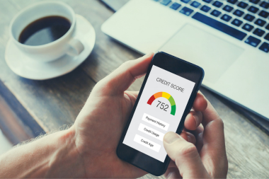 mistakes to avoid while financing your home remodel homeowner checking credit score on smartphone custom built michigan