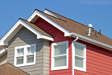 common mistakes to avoid while choosing your roof replacement material modern home with brown shingles and multi colored siding custom built michigan