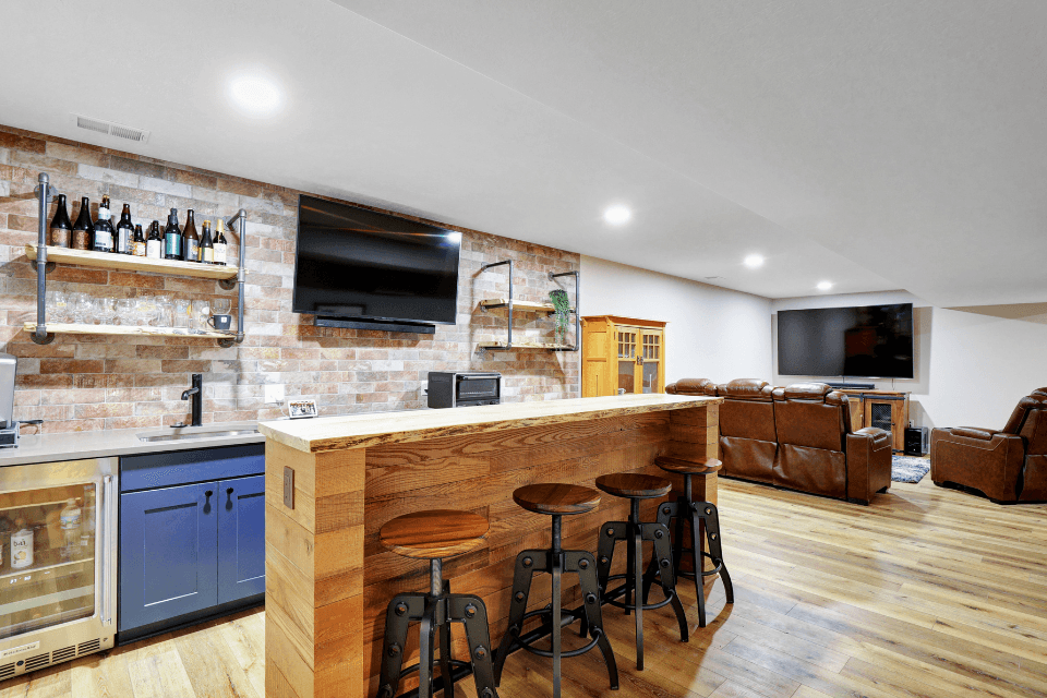finished basement bar remodeling project with stools TV seating area custom built michigan