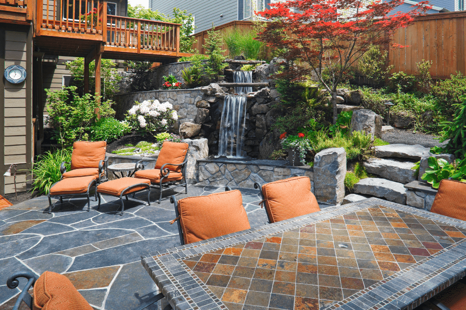 how much does an outdoor living space cost in Northern Michigan patio and deck with stairs waterfall