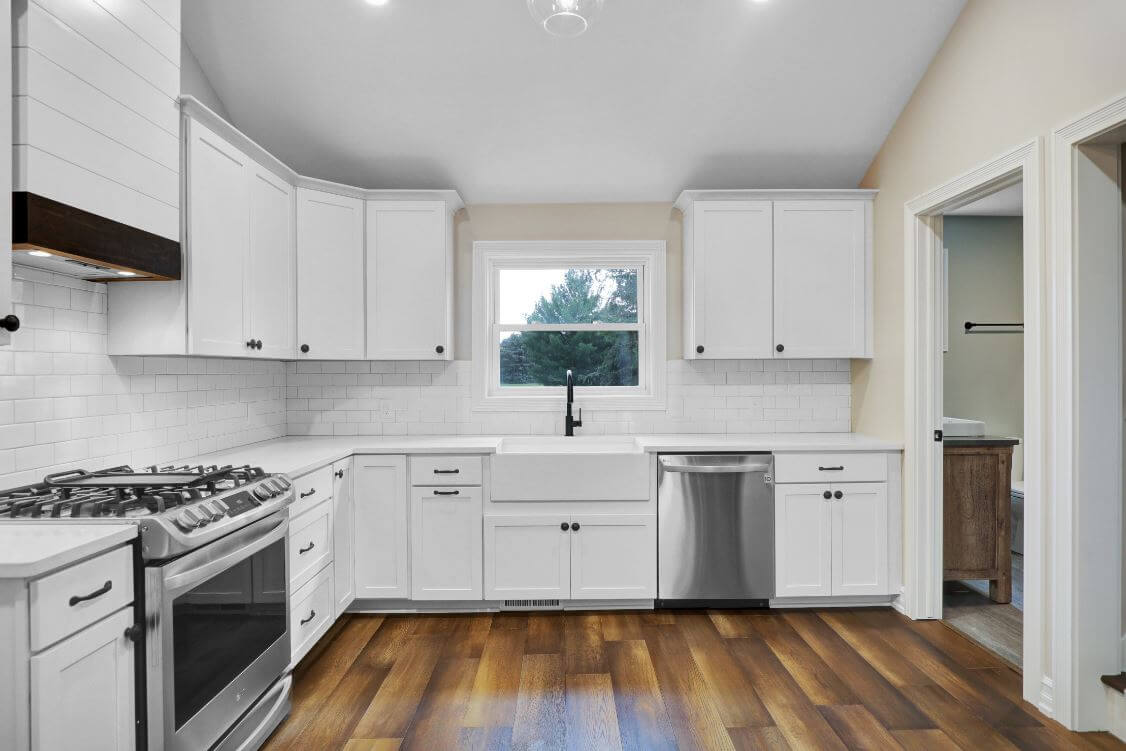 White kitchen cabinets and hardwood floors