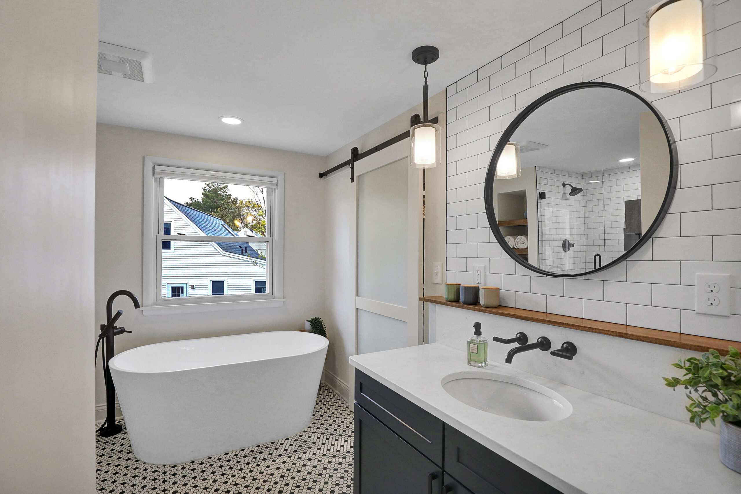 Updated bathroom with freestanding tub and barn door