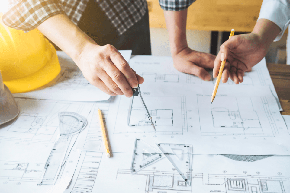 design build firm contractors working on home remodeling blueprints custom built michigan