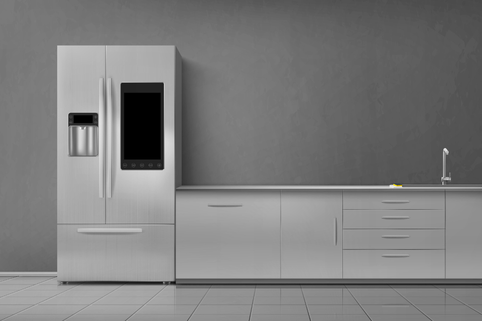 Smart refrigerator in a modern kitchen, with cabinets and sink. Grey wall 