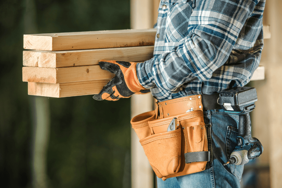 what to expect during the construction phase of your remodel contractor carrying lumber wood custom built